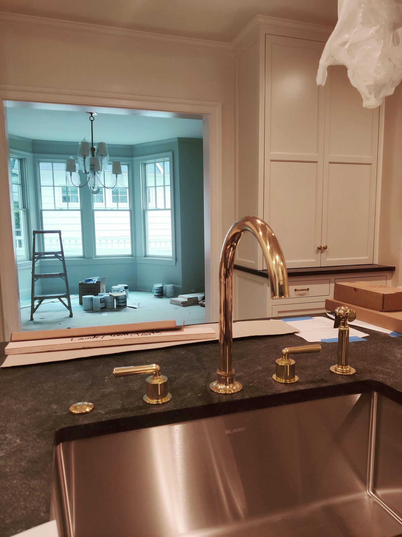 Modern kitchen remodel by GPIS with copper sink and premium fixtures